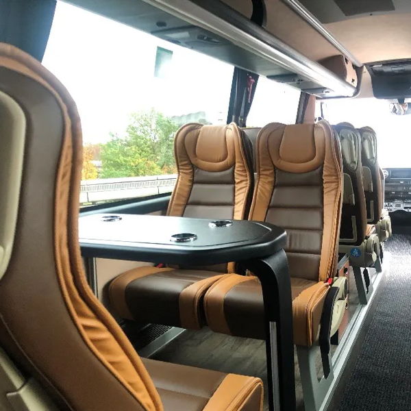 Interior of a luxury VIP bus with conference table.